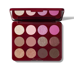Makeup palette with various shades of eyeshadow on a white background