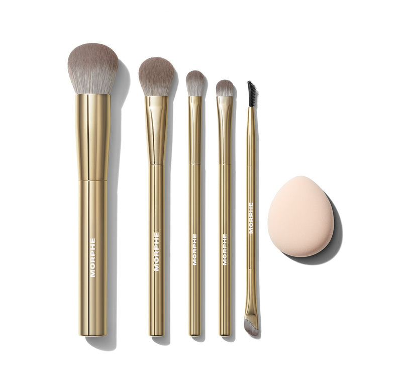 Five gold makeup brushes and one tan makeup puff